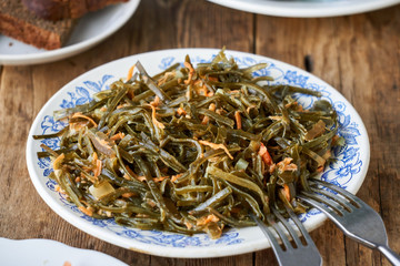 Salad with seaweed and carrots on a white plate 