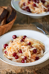 Sauerkraut with cranberries in a white bowl  