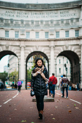 Fototapeta na wymiar Asian model walking on London street