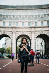 Fototapeta na wymiar Asian model walking on London street
