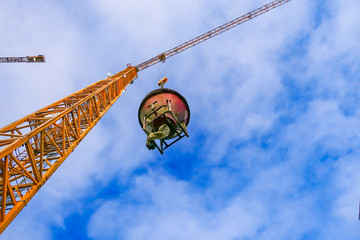 Stockholm, Sweden A crane lifts up a cement mixer.