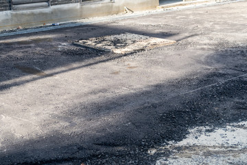 manhole cover with new asphalt