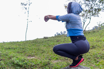 Woman exercising in the field