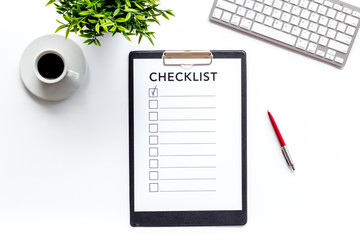 Checklist on white office background top view