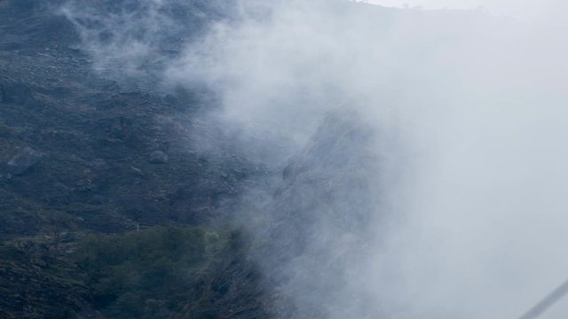 Day Timelapse of Fog/clouds coming in and going away from a hill/mountain around Manang, Nepal. Tight Shot.
