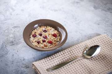 Fototapeta na wymiar Baked granola with milk and cranberries in a plate. Healthy breakfast. Tasty muesli, snack.