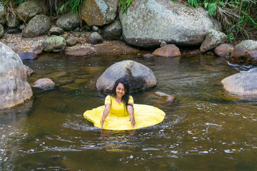 beautiful woman with yellow dress inside the water