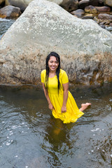 beautiful woman with yellow dress inside the water