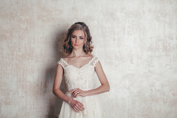 Fototapeta na wymiar beautiful bride posing wedding hairstyle and dress vintage