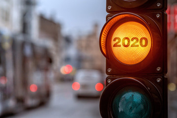 A city crossing with a semaphore. Orange light with text 2020 in semaphore. Symbolic New Year...