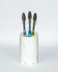 Toothbrush in the ceramic glass  isolated on white background