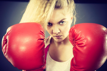 Angry woman wearing boxing gloves