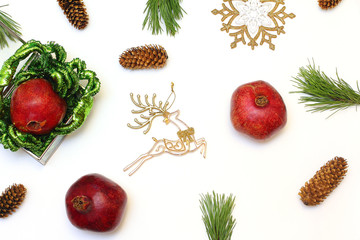 Beautiful Christmas pattern laid out fruit, branches, cones and toys. New year decor for white background. Top view, flat lay