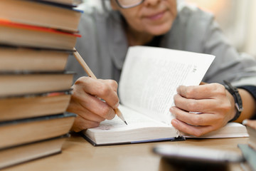 woman in the library in front of bookshelves. Concept of education