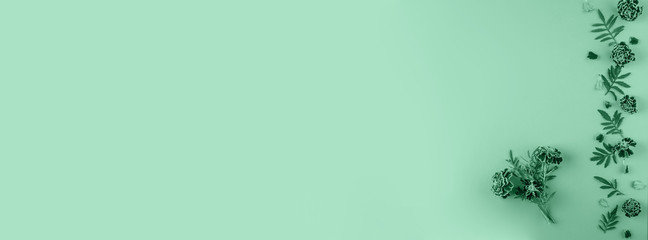 Flat lay composition with marigold flowers in trendy neo mint color toned.