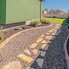 Obraz premium Square frame Landscaped garden pathway and suburban backyard day
