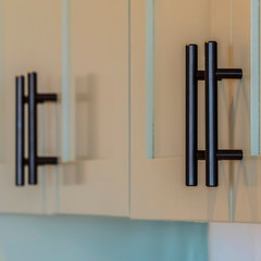 Square Close up of kitchen cupboards and black handles