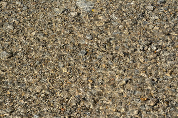 Blurred pebbles underwater, in a river in Provence. South of France.