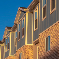 Square Townhomes on a neighborhood with vibrant blue sky background on a sunny day