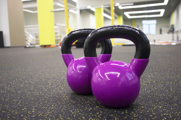 Naklejka na ściany i meble two kettlebells on the floor in the gym, the concept of sports and exercise