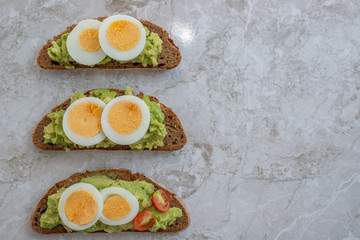 sliced avocado and egg on toasted bread for healthy breakfast