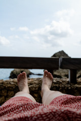 looking at a man's legs relaxing by the sea