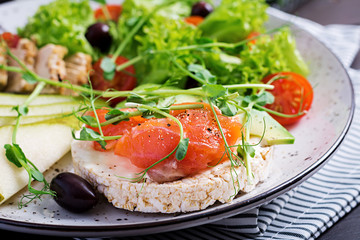 Healthy breakfast. Sandwiches with cream cheese,  salmon, avocado and slice pear on plate.