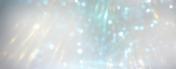 abstract background of glitter vintage lights . silver and white. de-focused