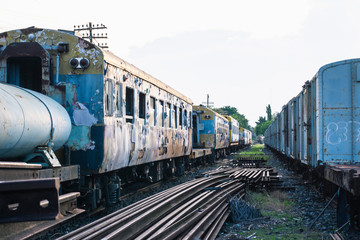 Fototapeta na wymiar Abandoned trains and an old iron trestle bridge
