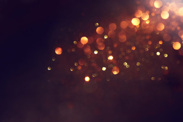 background of abstract glitter lights. gold and black. de focused