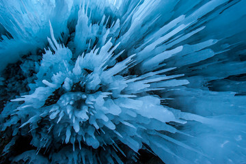 Fototapeta na wymiar Natural texture background of icicles in a cave on Lake Baikal. Blue beautiful color of ice.
