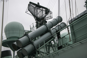 Missile launcher and radar system on a NATO warship. Rainy gloomy weather.