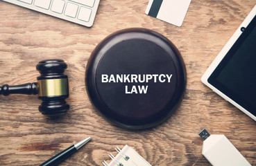 Wooden judge gavel with a other objects. Bankruptcy Law