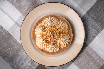 Cake basket with salted caramel on a checkered napkin top view.