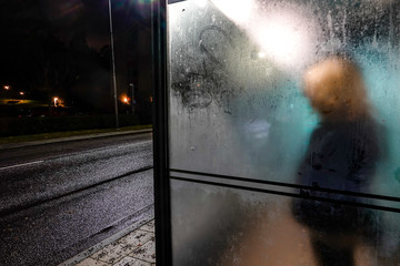 Stockholm, Sweden A woman waits alone at a bus stop in Lidingo.