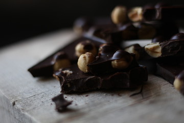 broken pieces of black chocolate with nuts