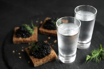 Foto op Plexiglas Cold Russian vodka and sandwiches with black caviar on table, closeup © New Africa