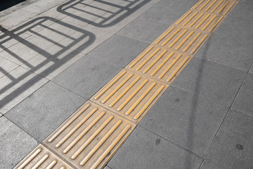 Tactile paving on footpath for blind pedestrians
