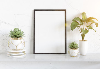 Black frame leaning on white shelve in bright interior with plants and decorations mockup 3D...