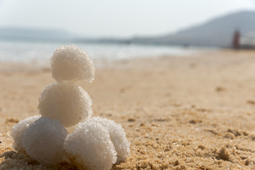 Fototapeta na wymiar Relax balls of salt on the sand. Sky horizon. Sea. Sand.