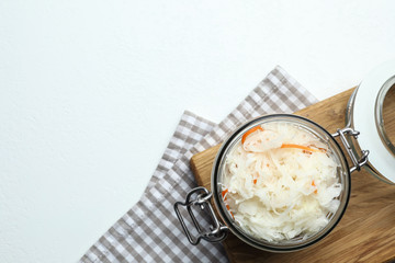 Tasty fermented cabbage on white table, top view. Space for text