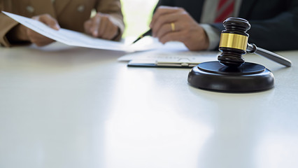 Judge gavel with Justice lawyers having team meeting at law firm background. Concepts of Law and...