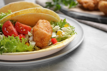 Delicious fish tacos served on marble table, closeup