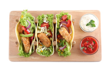 Board with tasty fish tacos isolated on white, top view