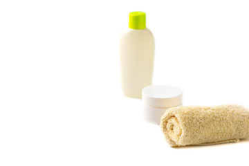 Obraz na płótnie Canvas Mock up of baby bath products: yellow shampoo bottle or shower gel bottle, towel and toy boat on white background. Close up, copy space for text, soft focus. Concept of baby bath accessories.