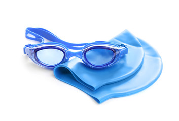 Swim goggles and cap isolated on white. Beach objects
