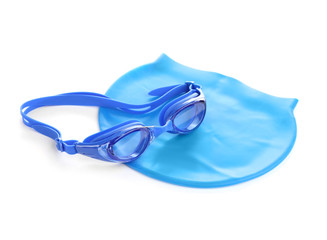 Swim goggles and cap isolated on white. Beach objects