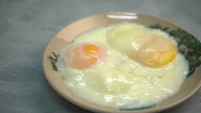 Asian traditional breakfast combination of half boiled eggs, toast bread with butter and kaya and coffee