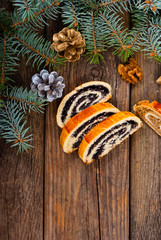 poppy and walnut roll cakes, pine branch, old wood table