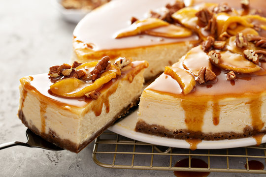 Apple caramel pecan cheesecake with dripping sauce with a slice cut out